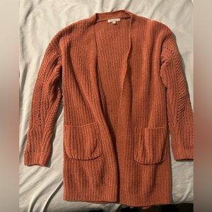 Cardigan. Burnt orangish/pink color